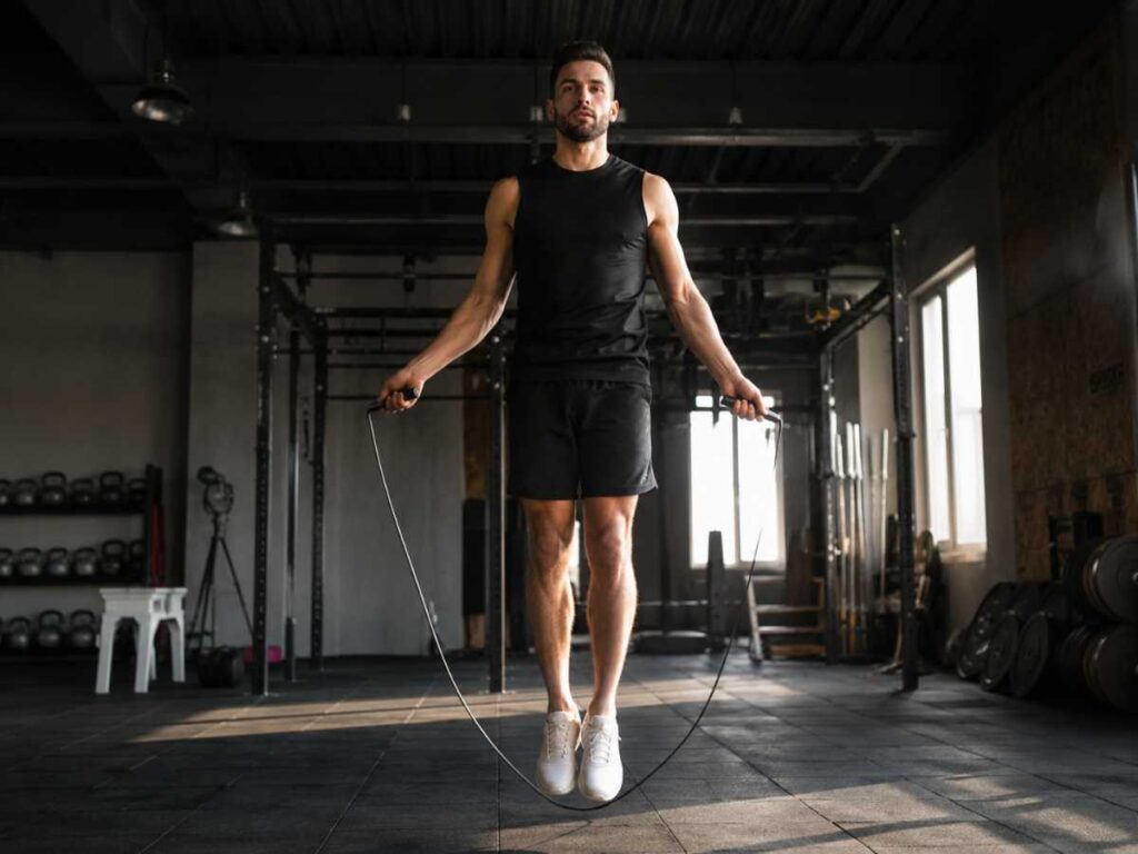 Athlete jumping rope on a gym floor with focus and rhythm, showcasing one of the best endurance exercises ever invented.